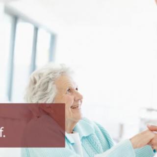 An elderly person smiling and interacting indoors.