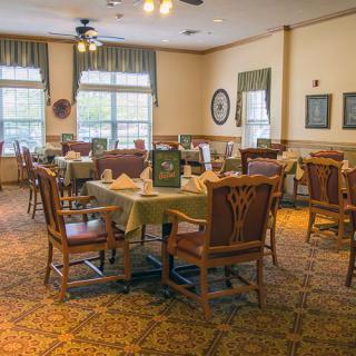 A cozy dining room with neatly arranged tables and chairs, ready for guests.