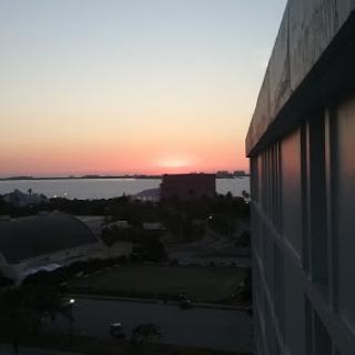 A peaceful sunset over the water, viewed from a building.