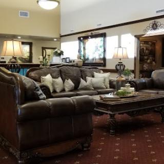 A cozy living room setup featuring a comfortable sofa with decorative pillows and a stylish coffee table.