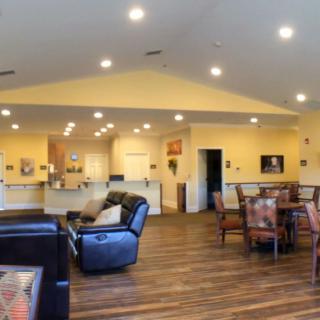 Spacious open-concept living area with modern furnishings and hardwood floors.