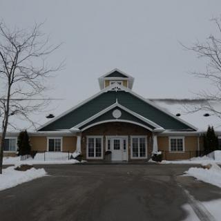 A snow-covered building with a prominent entrance.