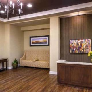 A warmly decorated lobby with a reception desk and comfortable seating.