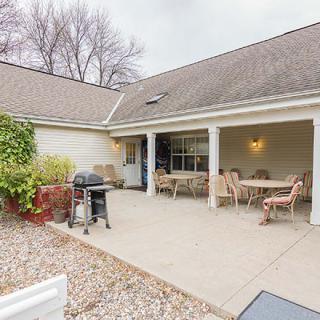 A cozy patio with outdoor seating and a grill.
