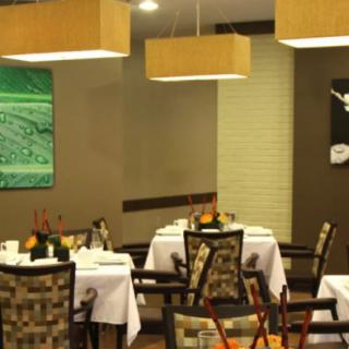 A cozy restaurant interior with tables set for dining.