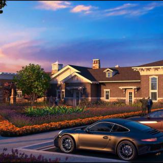 A luxury car parked in front of an elegant house at sunset.