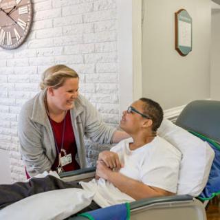 A nurse providing compassionate care to a patient in a medical setting.