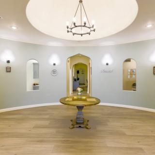 A beautifully designed interior room with a central fountain and elegant chandelier.
