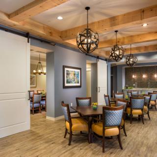 A modern dining area with stylish lighting and wood accents.