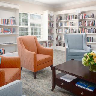 A cozy library with comfortable seating and well-organized bookshelves.