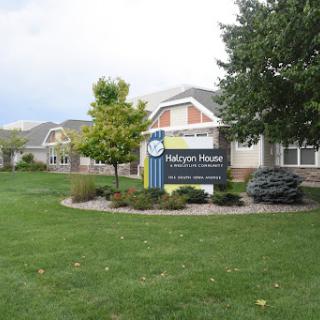 Exterior view of a residential facility with a landscaped lawn.