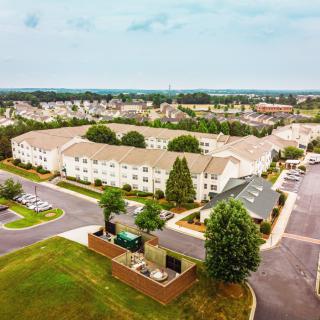 Aerial view of a suburban neighborhood with residential buildings and green spaces.