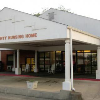 Entrance to a nursing home facility during daylight.