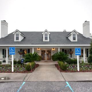 A charming house with a symmetrical design, featuring chimneys and landscaped surroundings.