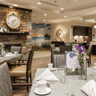 An elegantly furnished restaurant interior with neatly arranged tables and chairs.