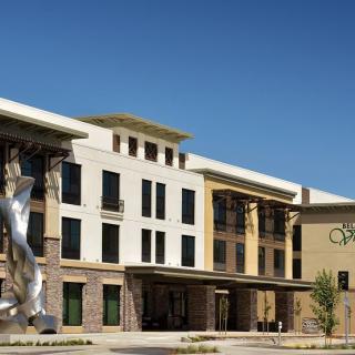 A modern building with a prominent outdoor sculpture.