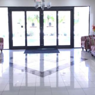 A bright and spacious lobby with glass doors leading outside.