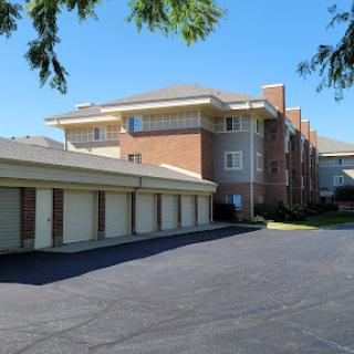 A modern residential building with attached garages and a clear blue sky.