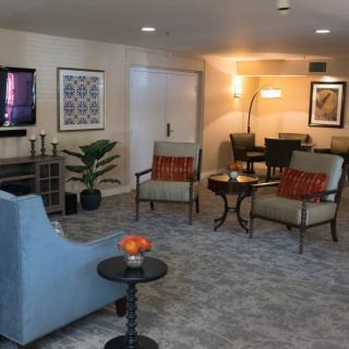 A cozy living room featuring comfortable seating, a TV, and decorative elements.