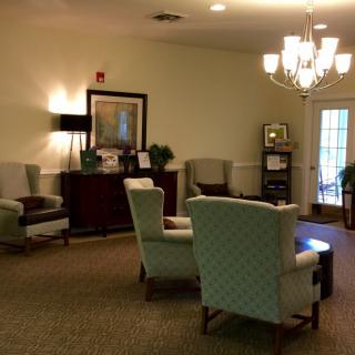 A cozy lounge area with comfortable chairs and warm lighting.