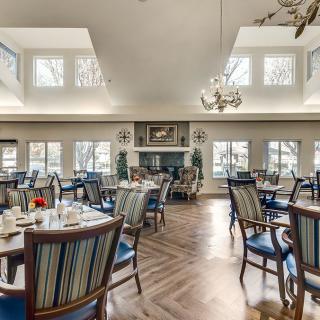 A well-lit dining area with elegant furnishings and large windows.
