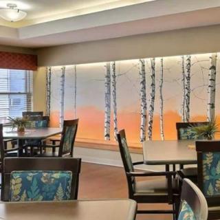 A modern dining area with stylish wall art and comfortable seating.