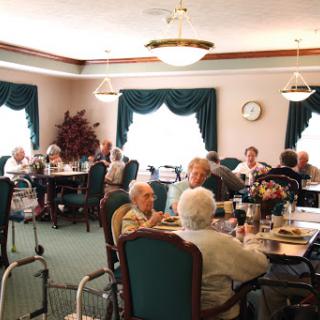 A lively gathering of seniors enjoying a meal together in a cozy dining area.