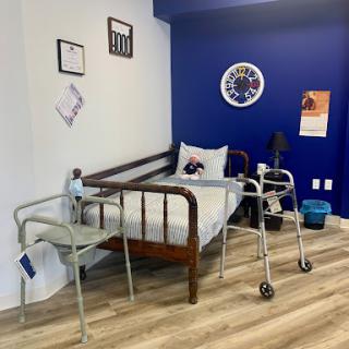 A hospital room featuring a bed and walking aids, designed for patient recovery.