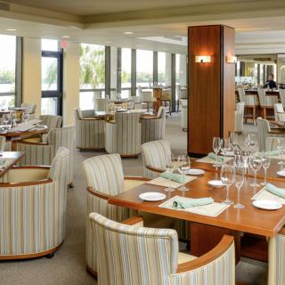 An elegant restaurant dining area with neatly set tables and comfortable seating.