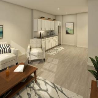 A modern, minimalist living room with an integrated kitchen area, featuring neutral tones and stylish furniture.