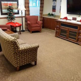 A cozy living room with comfortable seating, a large television, and decorative elements.