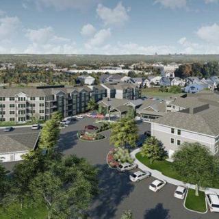 Aerial view of a residential apartment complex surrounded by greenery.