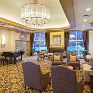 A luxurious lounge with elegant furnishings and a grand piano.