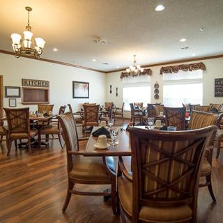 A cozy dining area with wooden furniture and warm lighting.