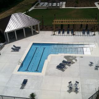 Aerial view of an outdoor swimming pool area with lounge chairs and a gazebo.