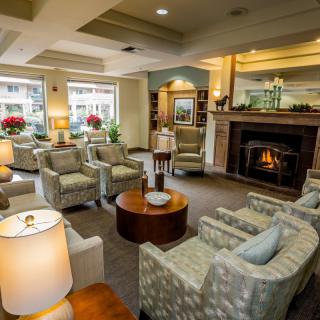 A cozy living room with a warm fireplace and comfortable seating arrangements.