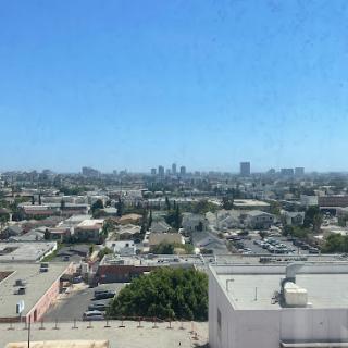 A panoramic view of the city skyline under a clear blue sky.
