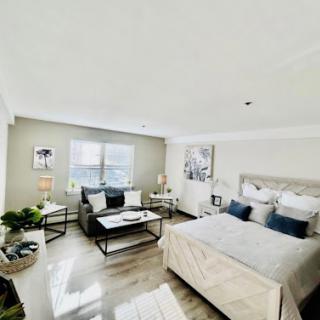 A bright and modern bedroom featuring elegant decor and comfortable furnishings.