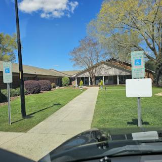 A clear day showcasing a well-maintained building with accessible parking spaces.