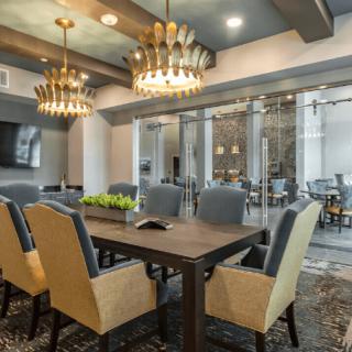 A modern dining room with elegant chandeliers and stylish furniture.