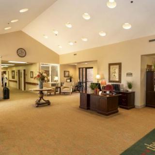 A well-lit lobby area with a reception desk and seating.