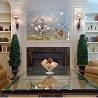 Elegant living room with a mirrored wall and cozy fireplace.