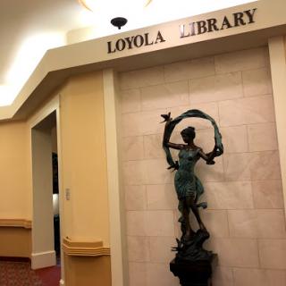 Entrance to the Loyola Library featuring a decorative statue.