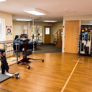 A physical therapy room equipped with exercise machines and tools for rehabilitation.