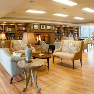 A cozy lounge area with comfortable seating and a warm fireplace.