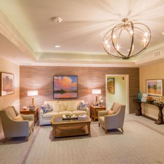 A cozy and elegantly decorated living room with modern furnishings and a stylish chandelier.