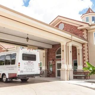 A hotel's shuttle bus parked at the main entrance.