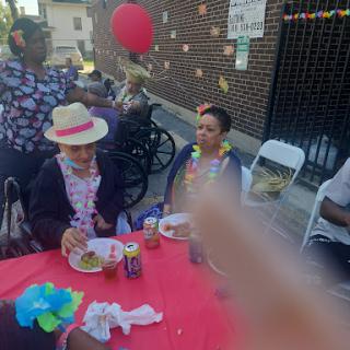 A joyful outdoor celebration with community members enjoying food and festivities.