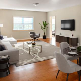 A beautifully designed modern living room featuring minimalist furniture and ample natural light.