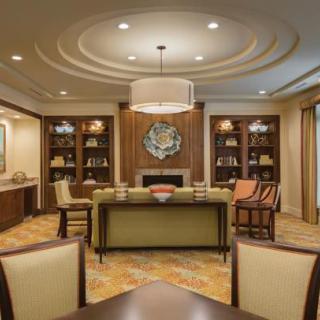 A luxurious and elegantly designed living room with comfortable seating, stylish bookshelves, and ambient lighting.